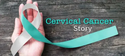 Teal cervical cancer awareness ribbon held in a hand